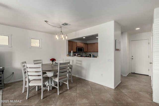 dining area with light tile patterned flooring, recessed lighting, visible vents, baseboards, and an inviting chandelier