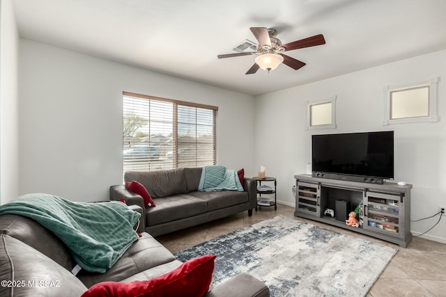 living room featuring a ceiling fan, light tile patterned flooring, and baseboards