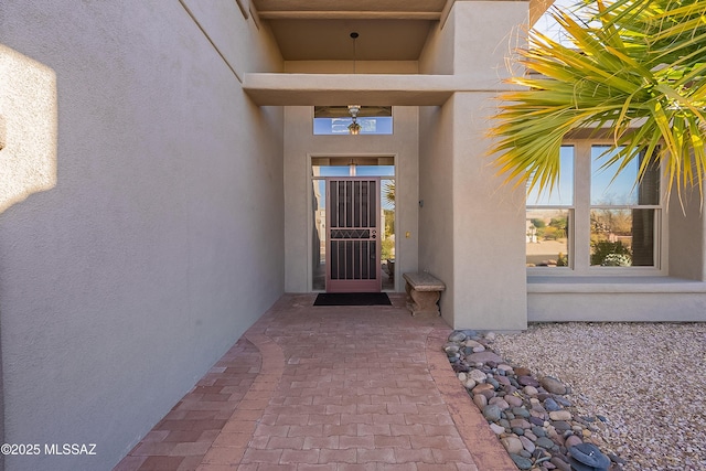 view of exterior entry featuring stucco siding