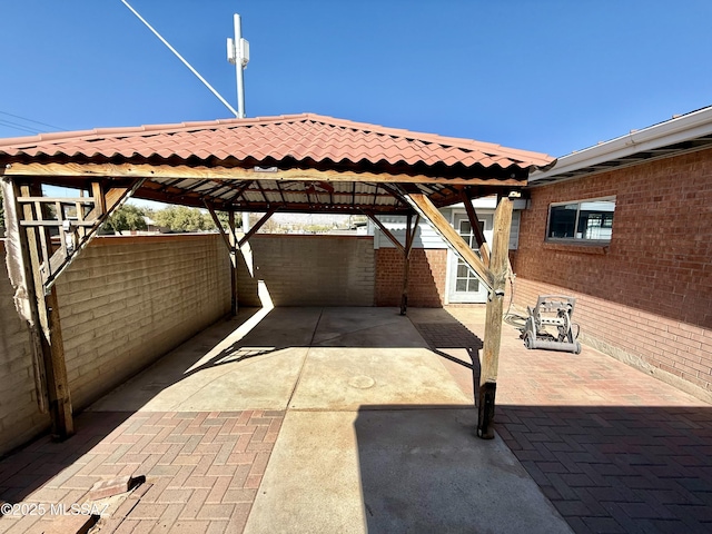 view of patio / terrace featuring a carport and fence