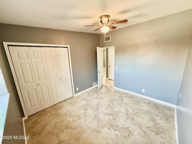 unfurnished bedroom with ceiling fan, a closet, visible vents, and baseboards