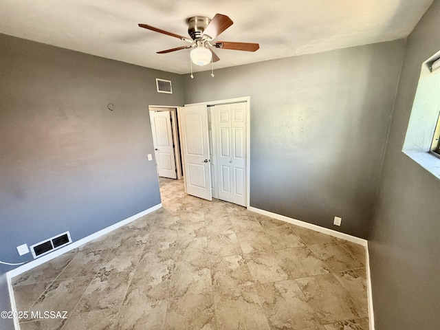 unfurnished bedroom featuring a closet, visible vents, ceiling fan, and baseboards