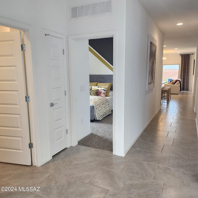 corridor with light tile patterned floors, visible vents, and recessed lighting