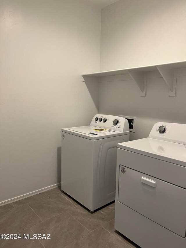 laundry area featuring laundry area, baseboards, washer and dryer, and tile patterned floors