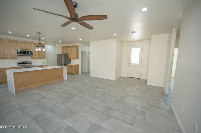 kitchen with recessed lighting, visible vents, open floor plan, light countertops, and appliances with stainless steel finishes