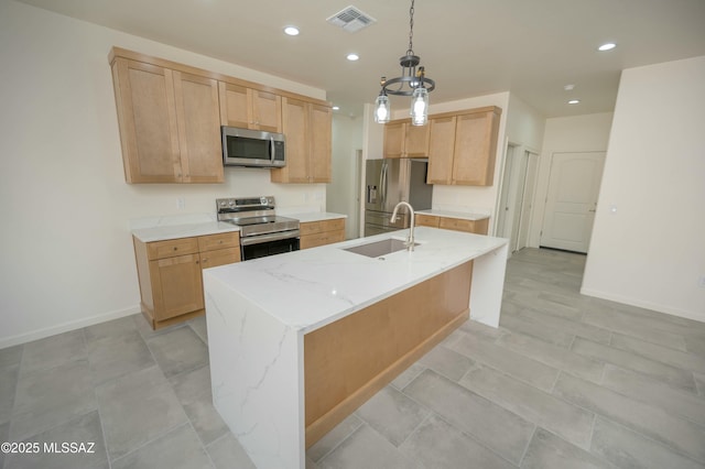 kitchen featuring visible vents, appliances with stainless steel finishes, light stone countertops, pendant lighting, and a sink