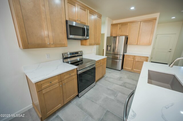 kitchen with light countertops, stainless steel fridge, baseboards, and recessed lighting