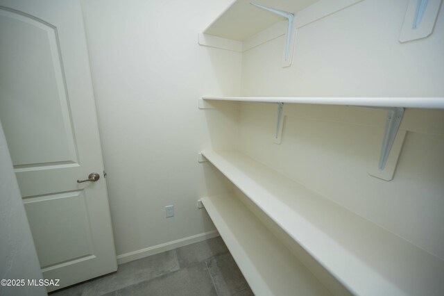 half bath featuring toilet, baseboards, and vanity