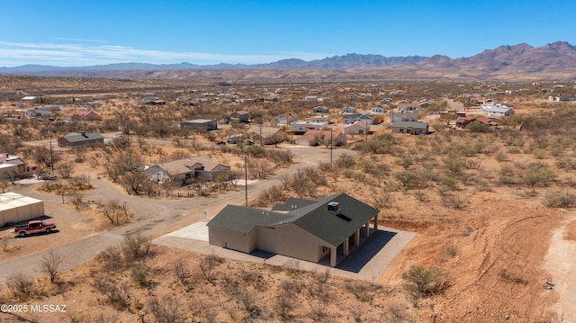 drone / aerial view featuring view of desert and a mountain view