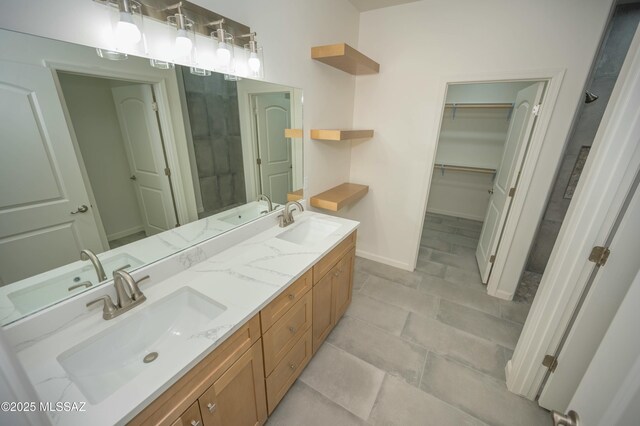 bathroom with a spacious closet and tiled shower