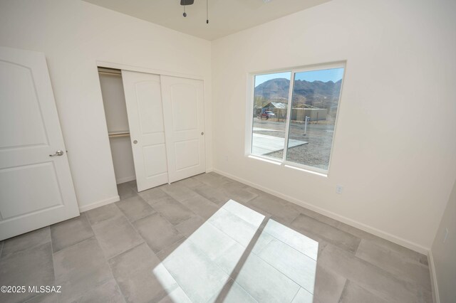 unfurnished bedroom featuring a closet and baseboards