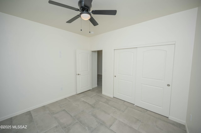 unfurnished bedroom with a closet, a ceiling fan, and baseboards