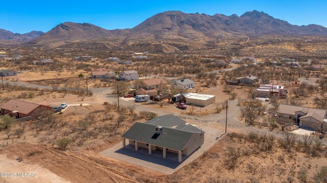 drone / aerial view with view of desert and a mountain view