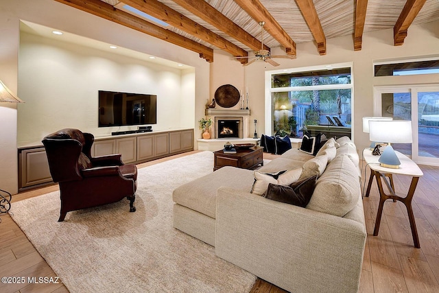 living area with wood ceiling, light wood-style floors, a fireplace, beam ceiling, and recessed lighting