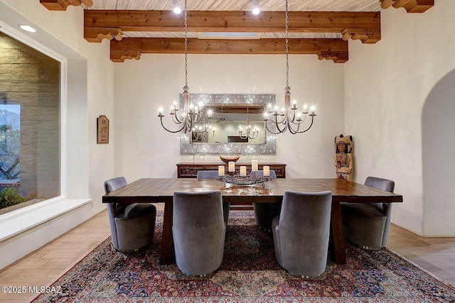 dining room with arched walkways, wooden ceiling, wood finished floors, and beam ceiling