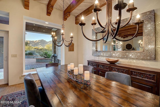 dining room with an inviting chandelier, beam ceiling, and light wood-style floors