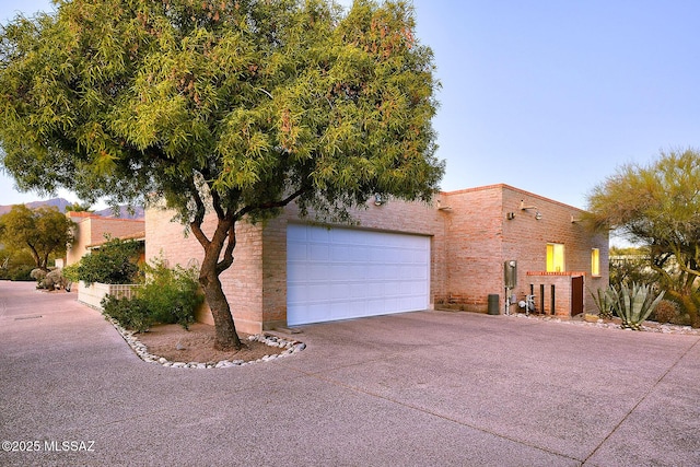 adobe home featuring concrete driveway