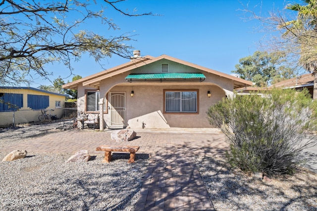 back of property featuring a patio area and stucco siding