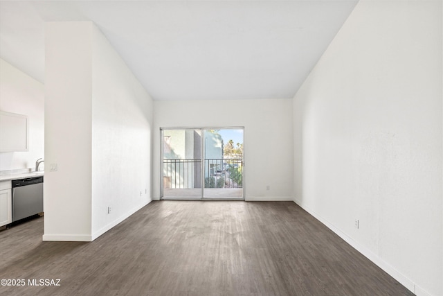 spare room with dark wood-type flooring and baseboards