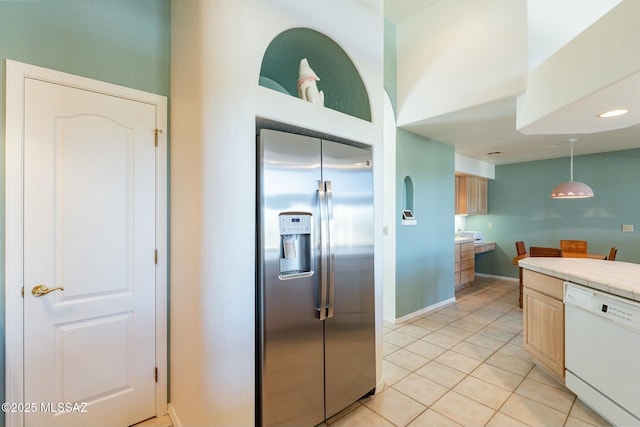 kitchen with light tile patterned floors, dishwasher, tile countertops, decorative light fixtures, and stainless steel refrigerator with ice dispenser