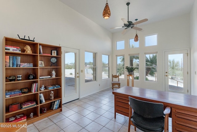 office featuring light tile patterned floors, high vaulted ceiling, and ceiling fan