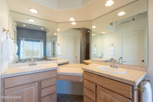 ensuite bathroom featuring tile patterned floors, connected bathroom, vanity, and recessed lighting