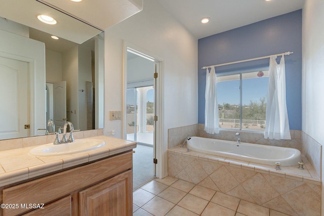 bathroom with a garden tub, tile patterned flooring, vanity, and recessed lighting