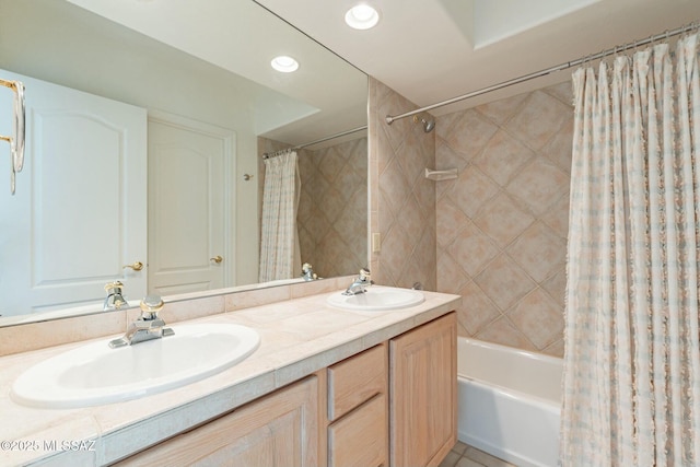 full bathroom with double vanity, a sink, shower / bath combo with shower curtain, and recessed lighting