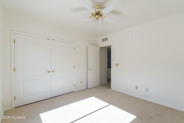 unfurnished bedroom with light carpet, a ceiling fan, visible vents, baseboards, and a closet