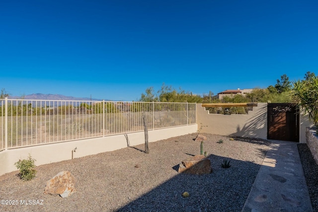 exterior space with a fenced backyard and a mountain view