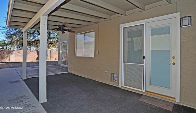 view of patio with ceiling fan and fence