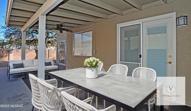 view of patio with outdoor dining area, ceiling fan, an outdoor living space, and fence