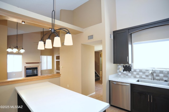 kitchen featuring visible vents, light countertops, stainless steel dishwasher, and decorative light fixtures