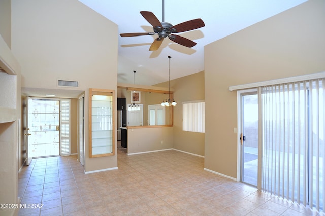 unfurnished room with high vaulted ceiling, baseboards, light tile patterned floors, and visible vents