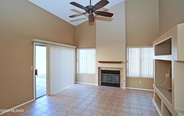 unfurnished living room with baseboards, a fireplace, and high vaulted ceiling