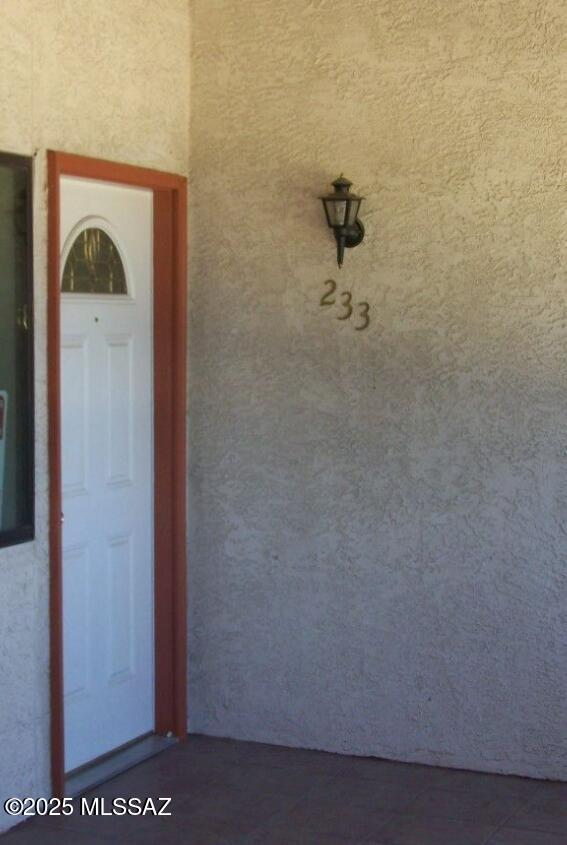 entrance to property with stucco siding