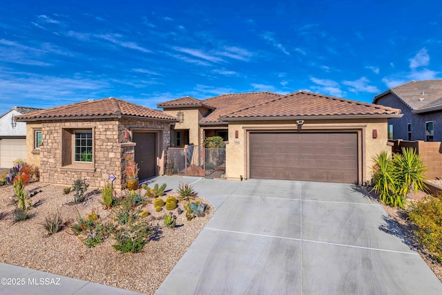 view of front of property featuring a garage, concrete driveway, stone siding, a tile roof, and stucco siding