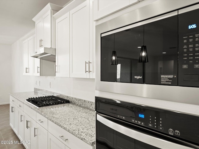 314 N Pecan Pie Pl, Sahuarita, AZ 85629 - kitchen with white cabinets, wall oven, under cabinet range hood, built in microwave, and stainless steel gas cooktop