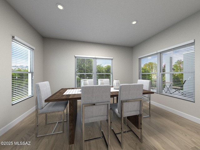 dining area with a wealth of natural light, recessed lighting, baseboards, and wood finished floors