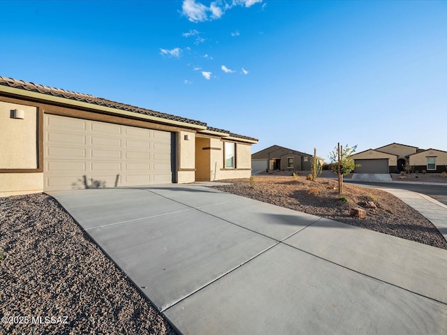314 N Pecan Pie Pl, Sahuarita, AZ 85629 - ranch-style home with driveway, a tiled roof, stucco siding, and an attached garage
