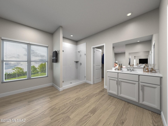 full bath with baseboards, wood finished floors, a tile shower, vanity, and recessed lighting