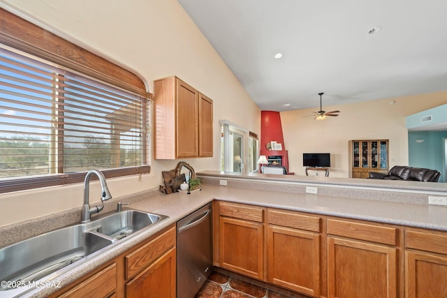 kitchen with ceiling fan, open floor plan, light countertops, stainless steel dishwasher, and a sink