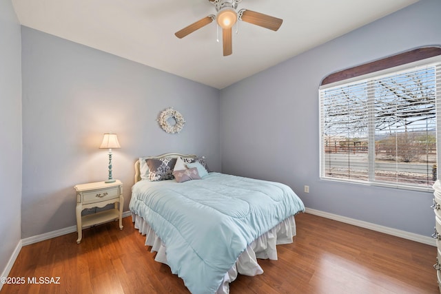 bedroom featuring ceiling fan, wood finished floors, and baseboards