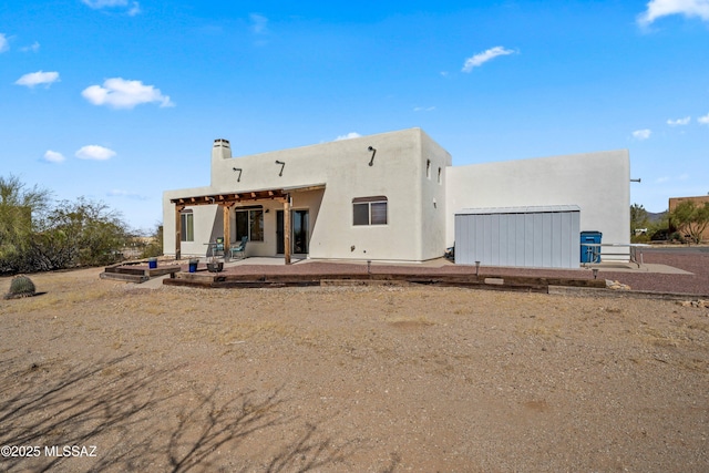 back of property featuring a patio and stucco siding