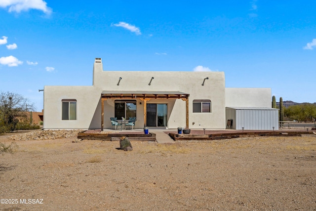 back of property featuring a patio and stucco siding