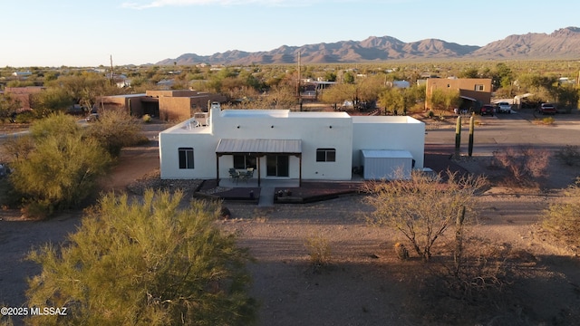 view of front of home with a mountain view and stucco siding