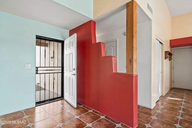 hallway with visible vents and tile patterned floors