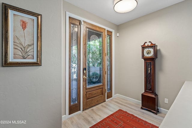 entryway featuring light wood finished floors and baseboards