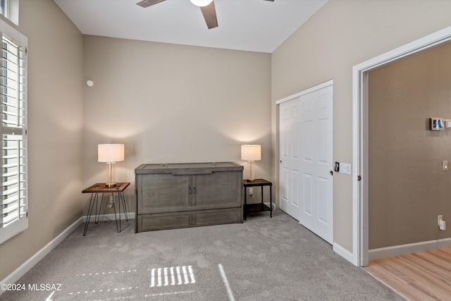 unfurnished room with ceiling fan, baseboards, and light colored carpet