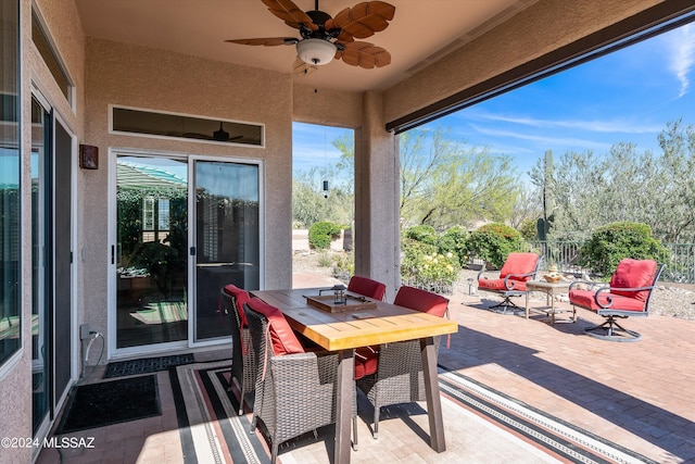 view of patio with ceiling fan, fence, and outdoor dining area